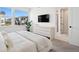 Serene bedroom features a large window, a dresser, and a door to the ensuite bathroom at 12270 W 57Th Ave, Arvada, CO 80002