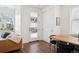 Bright dining room with modern decor, hardwood floors, and natural light from front door at 12270 W 57Th Ave, Arvada, CO 80002