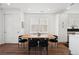 Elegant dining area features a modern light fixture, wooden table, and white trim at 12270 W 57Th Ave, Arvada, CO 80002