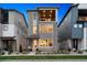 Contemporary three-story home featuring stone accents, a private balcony, and well-maintained landscaping at 12270 W 57Th Ave, Arvada, CO 80002