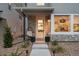 Charming front entryway with stone accents, stylish lighting, and a cozy hanging chair at 12270 W 57Th Ave, Arvada, CO 80002
