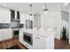 Bright, stylish kitchen with stainless appliances, an island with bar seating, and modern pendant lighting at 12270 W 57Th Ave, Arvada, CO 80002