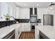 Modern kitchen boasts white cabinets, stainless steel appliances, an island, and black subway tile backsplash at 12270 W 57Th Ave, Arvada, CO 80002