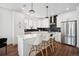 Bright, modern kitchen with a large island, white cabinetry, and stainless steel appliances at 12270 W 57Th Ave, Arvada, CO 80002