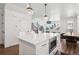 Modern kitchen with a large island, stainless steel microwave, and open layout to the dining area at 12270 W 57Th Ave, Arvada, CO 80002