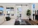 Open living space with views to balcony and office; features modern finishes and hardwood floors at 12270 W 57Th Ave, Arvada, CO 80002
