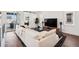 Inviting living room featuring modern furnishings, large TV, and sliding glass doors to a balcony at 12270 W 57Th Ave, Arvada, CO 80002