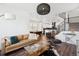 Open-concept living space with modern furnishings and staircase access to other floors at 12270 W 57Th Ave, Arvada, CO 80002
