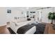 Comfortable living room area featuring a plush sectional sofa, modern rug, and sliding door access to an outdoor space at 12270 W 57Th Ave, Arvada, CO 80002