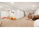 Finished basement area provides space for ' play area and comfortable seating around a bookshelf at 8276 E Easter Pl, Centennial, CO 80112