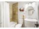 Cozy bathroom with a bathtub and shower, tile surround, and a vanity with a decorative mirror at 8276 E Easter Pl, Centennial, CO 80112