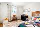 ' room with a fun rug, twin bed, patterned wallpaper, and natural light from the window at 8276 E Easter Pl, Centennial, CO 80112