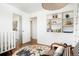 Bedroom featuring a rocking chair, playful decor, built-in shelves, and hardwood floors at 8276 E Easter Pl, Centennial, CO 80112