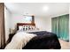 Relaxing bedroom with large bed, warm lighting, and stylish curtains at 8276 E Easter Pl, Centennial, CO 80112