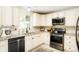 Modern kitchen with white cabinets, granite counters, stainless steel appliances and tiled floors at 8276 E Easter Pl, Centennial, CO 80112
