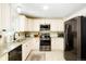 Well-lit kitchen featuring white cabinetry, granite countertops, and stainless steel appliances at 8276 E Easter Pl, Centennial, CO 80112