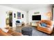 Open living room with hardwood floors, neutral walls, comfortable seating, and stylish decor at 8276 E Easter Pl, Centennial, CO 80112