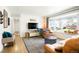 Bright living room with hardwood floors, neutral walls, stylish furniture and large bay window at 8276 E Easter Pl, Centennial, CO 80112