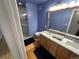 Bright blue bathroom with double sink vanity, tile shower, and modern fixtures at 1555 California St # 610, Denver, CO 80202