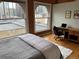 Bedroom with hardwood floors, desk, and large windows overlooking city at 1555 California St # 610, Denver, CO 80202