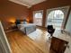 Bedroom with hardwood floors, large windows, and a desk at 1555 California St # 610, Denver, CO 80202