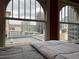 Bedroom with city views from large windows and comfortable bedding at 1555 California St # 610, Denver, CO 80202