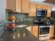 Kitchen featuring stone countertops, a stainless steel oven, and unique backsplash at 1555 California St # 610, Denver, CO 80202