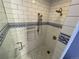 Modern tiled shower with mosaic accents, handheld sprayer, and built-in niche at 1555 California St # 610, Denver, CO 80202