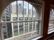 Arched window view featuring the city skyline and a historic building at 1555 California St # 610, Denver, CO 80202