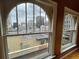 Arched windows frame a vibrant cityscape, offering natural light and an urban aesthetic at 1555 California St # 610, Denver, CO 80202