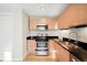 Modern kitchen with stainless steel appliances and wood cabinets at 2837 Vallejo St # 108, Denver, CO 80211