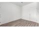 Bright and airy bedroom featuring wood-look floors and neutral walls at 5783 N Jericho Way, Aurora, CO 80019