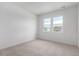 Bright bedroom with cozy carpet and natural light from the double window at 5783 N Jericho Way, Aurora, CO 80019