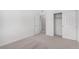 Bright bedroom featuring a neutral carpet, closet, and white interior door at 5783 N Jericho Way, Aurora, CO 80019