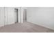 Bright bedroom features a neutral carpet, closet, and white interior doors at 5783 N Jericho Way, Aurora, CO 80019