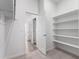 Organized walk-in closet with shelving and convenient access to adjacent rooms at 5783 N Jericho Way, Aurora, CO 80019
