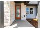 Close-up of front door with modern design and stone exterior at 5783 N Jericho Way, Aurora, CO 80019