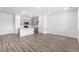 Inviting living room with wood-style floors seamlessly flowing into a modern kitchen at 5783 N Jericho Way, Aurora, CO 80019