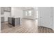 Open living area with modern kitchen, wood-look flooring, and ample natural light at 5783 N Jericho Way, Aurora, CO 80019