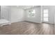 Bright living room with wood-style flooring and natural light from the double window at 5783 N Jericho Way, Aurora, CO 80019