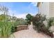 View of backyard with patio, decorative stone retaining wall and mature landscaping at 10559 Sedalia St, Commerce City, CO 80022