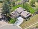 Aerial view of home featuring landscaped yard, a circular driveway, and a tile roof at 6490 S Pontiac Ct, Centennial, CO 80111