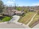 Spacious home boasting a long driveway, beautiful landscaping, and a well-maintained yard at 6490 S Pontiac Ct, Centennial, CO 80111