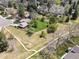 Aerial view of home with large yard featuring mature trees, manicured lawn, and fenced perimeter at 6490 S Pontiac Ct, Centennial, CO 80111