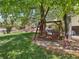 Wooden swing set amidst the lush, green backyard at 6490 S Pontiac Ct, Centennial, CO 80111