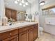 Bathroom vanity features warm wood and ample cabinet space at 6490 S Pontiac Ct, Centennial, CO 80111