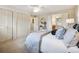 Bedroom featuring a comfortable bed, large closets, and access to the bathroom at 6490 S Pontiac Ct, Centennial, CO 80111