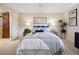 Well-lit bedroom featuring a comfortable bed, stylish decor, and neutral color palette at 6490 S Pontiac Ct, Centennial, CO 80111