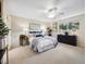 Comfortable bedroom with a ceiling fan, area rug, and a large window to welcome natural light at 6490 S Pontiac Ct, Centennial, CO 80111
