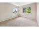 Bedroom with two windows letting in natural light and a neutral color scheme at 6490 S Pontiac Ct, Centennial, CO 80111